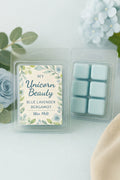 Wax melt packaging with a floral label on a white surface with flowers in the background