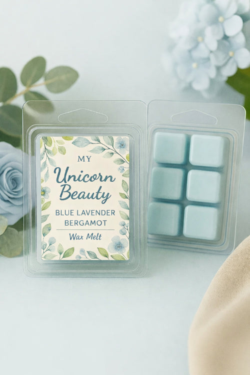 Wax melt packaging with a floral label on a white surface with flowers in the background