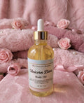 Bottle of 'My Unicorn Beauty Unicorn Diva' body oil on a pink floral background