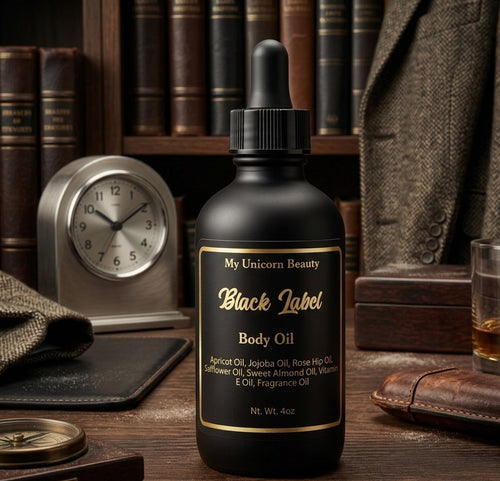 Black label body oil bottle on a wooden surface with books and a clock in the background