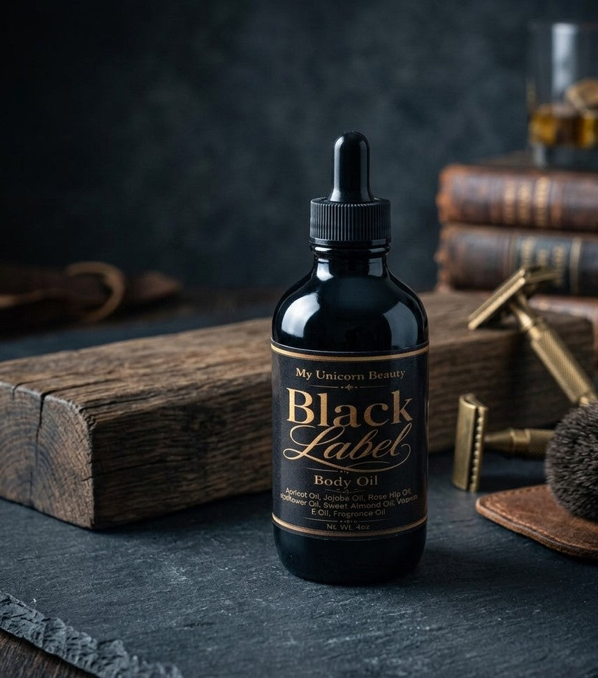 Bottle of 'Black Label' body oil on a dark surface with vintage books and tools in the background.