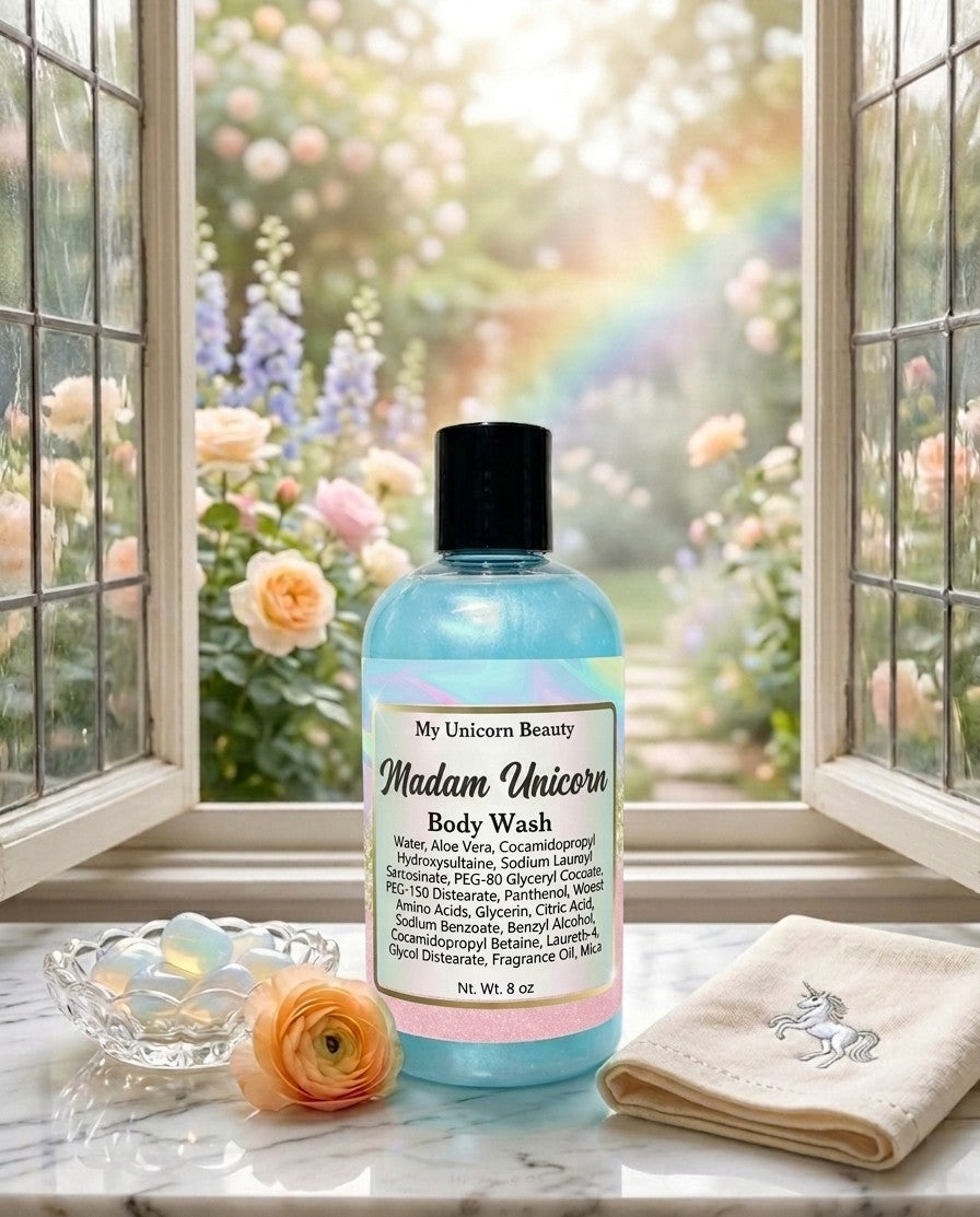 Bottle of Madam Unicorn body wash on a windowsill with flowers and a rainbow outside