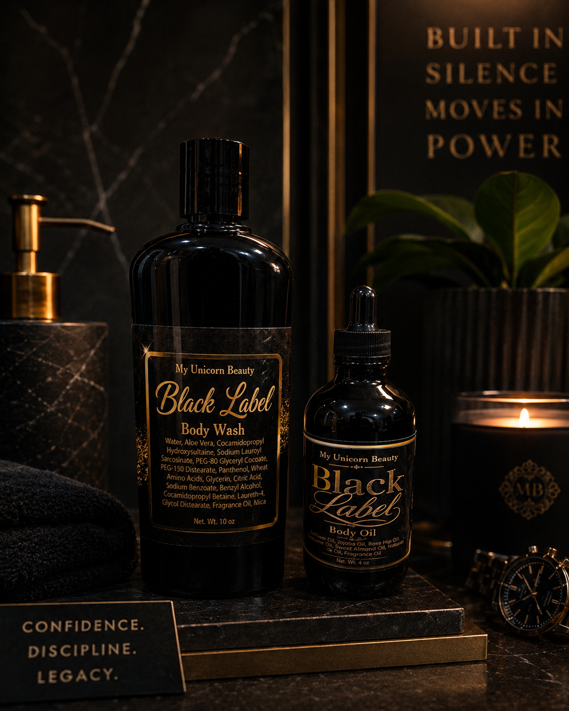 Two black labeled bottles of 'My Unicorn Beauty' Black Label Body Wash and Body Oil on a dark surface with decorative elements.