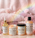 Collection of 'My Unicorn Beauty' skincare products with a rainbow and pink roses in the background.