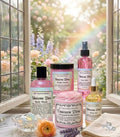 Collection of Unicorn Diva beauty products with a rainbow and flowers in the background.